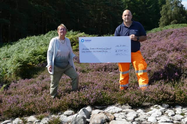 Tarmac quarry manager Gareth Williams presents a £3,500 cheque to Jan Frazer, secretary of the Holystone History & Archaeology Group.