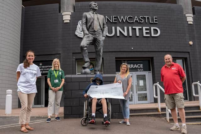 Connor Todd and his mum Clair present a cheque to Toon to Town at St James' Park following his fundraising efforts earlier this year.