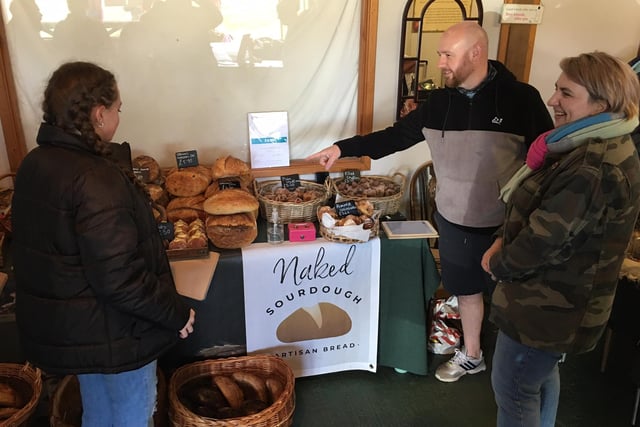 Kevin and Cristina Wood of Naked Sourdough help a customer decide.