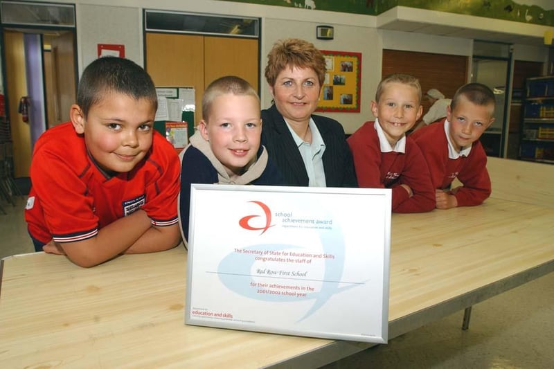 Red Row First School headteacher Linda Brett and four of the pupils celebrate the school's Certificate Of Achievement in May 2003.