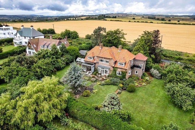 An aerial view of the home and its mature gardens.