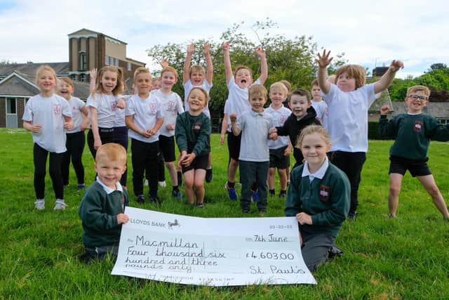 St Paul's pupils with a cheque for £4,603 for Macmillan.