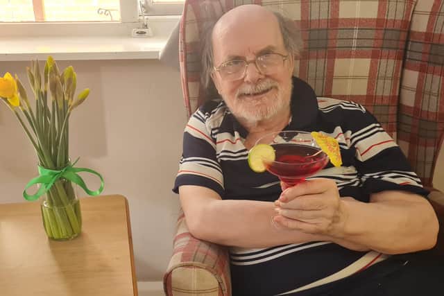 Resident Raymond Pringle, 78, with his woo woo cocktail at the Mardi Gras party.