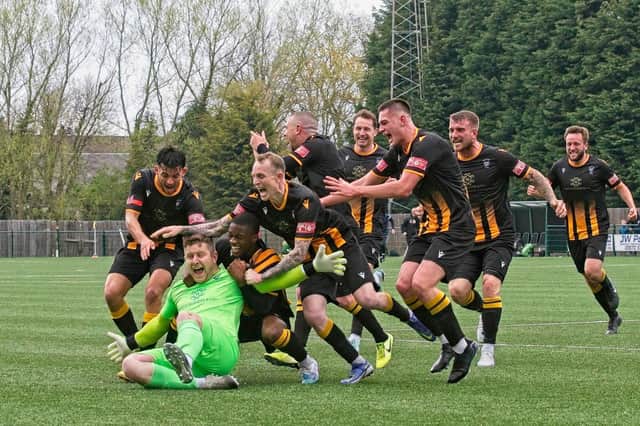 Morpeth Town keeper Dan Lowson is mobbed after scoring a 95th minute equaliser against Warrington Rylands. Picture: George Davidson.