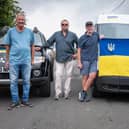 Graeme Reavley (centre, holding flag) with the team of volunteers.