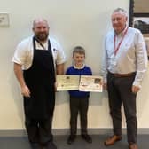 Competition winner James Coyne receives his certificates from Richard Bell and Vin McDonald.
