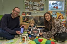 Tom Bowes and son Ethan find out about the DadPad with Hannah Brydon, Family Hub community development worker.