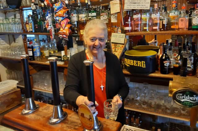 Brenda Collins behind the bar at The Free Trade Inn, Berwick.