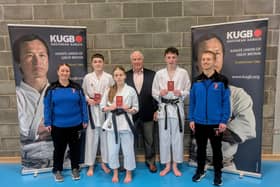 Jack Kingsland, Emelia Walker and Liam Stead with Sensei Dylan Gibson and Sensei Gemma Gibson, and grading examiner Sensei Frank Brennan.