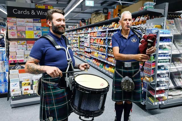 Drummer Stephen Walker and piper Andrew Miller at the new store.
Photo: John Millard/UNP