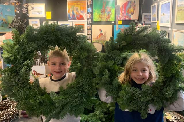 Thomas and Alice Wooldridge with the Christmas wreaths being sold at The Alnwick Gallery.