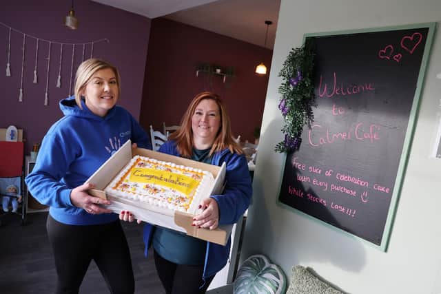 Christie and Donna from Calmer Therapy opened the cafe with a celebratory cake. (Photo by Helen Smith)