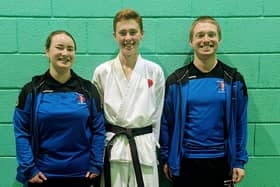 Isaac after successfully passing his black belt with club instructors Sensei Dylan Gibson and Sensei Gemma Gibson.