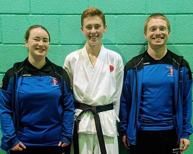Isaac after successfully passing his black belt with club instructors Sensei Dylan Gibson and Sensei Gemma Gibson.