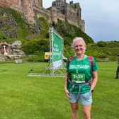 Charlotte Watson at the finish of the Northumberland Coastal Mighty Hike 2023 staged in front of Bamburgh Castle on Saturday 15 July 2023. (Photo submitted by Macmillan).