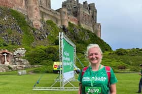 Charlotte Watson at the finish of the Northumberland Coastal Mighty Hike 2023 staged in front of Bamburgh Castle on Saturday 15 July 2023. (Photo submitted by Macmillan).