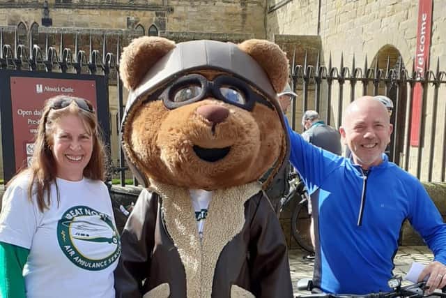 Colin Barnes, director, and Vanessa Proudlock, community engagement office, with air ambulance mascot Miles the Bear.
