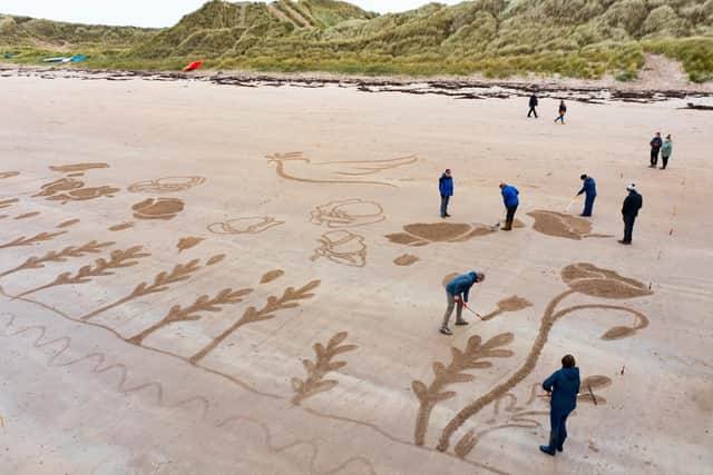 Volunteer sand artists at work.