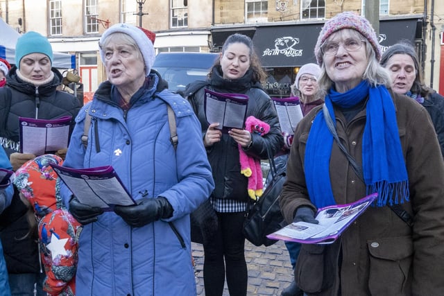 The singers took centre stage in the Market Place to sing festive songs.