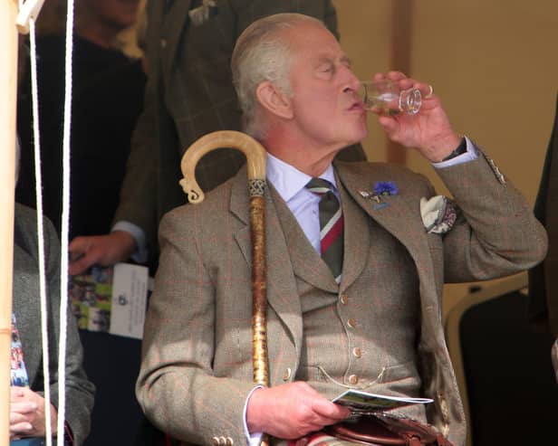 King Charles III enjoys a dram during the Mey Highland Games at the John O'Groats Showground in Caithness. Photo by Robert MacDonald/PA Wire