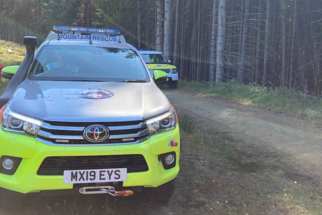 Mountain rescue vehicles at the scene.