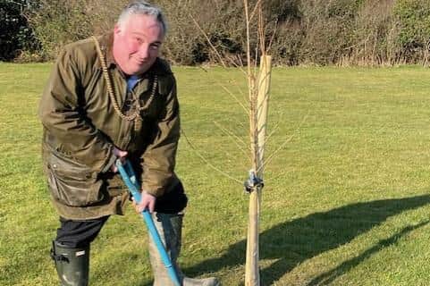 Coun David Bawn planting a tree on the entrance to Lancaster Park.