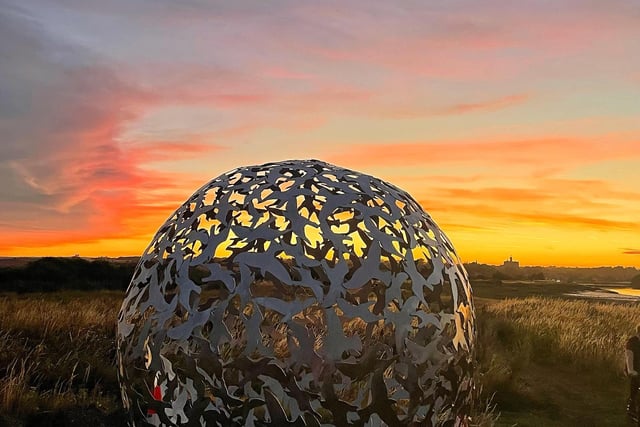 A beautiful sunset behind one of the sculptures.