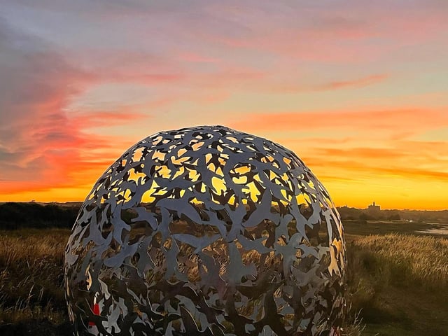A beautiful sunset behind one of the sculptures.