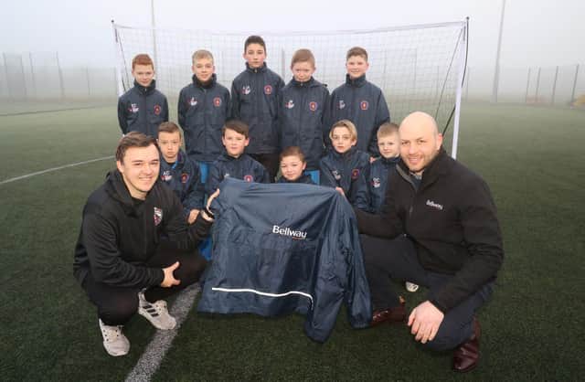 Cramlington United U11 Panthers football team, with coach Tom Adams and sales manager Chris Lawson of Bellway.