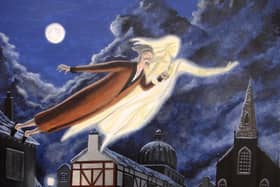 Scrooge and the Ghost of Christmas Past soar over the town on a moonlit Christmas Eve. Image by Dave Rheaume.