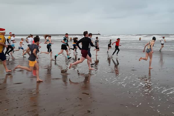 Runners head for the water at the Spittal beach Boxing Day Dip in 2021. Picture by Ian Smith.