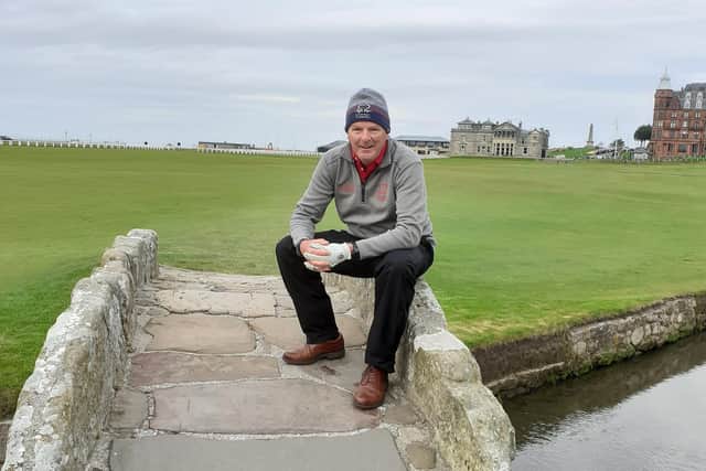 Alistair Collin pictured sitting on the Swilcan Bridge on the Old Course at St Andrews.