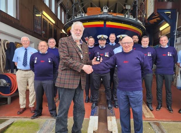 Members of Berwick-upon-Tweed RNLI crew receive Platinum Jubilee medals from Berwick Mayor Mike Greener.