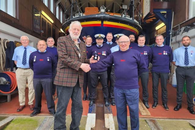 Members of Berwick-upon-Tweed RNLI crew receive Platinum Jubilee medals from Berwick Mayor Mike Greener.