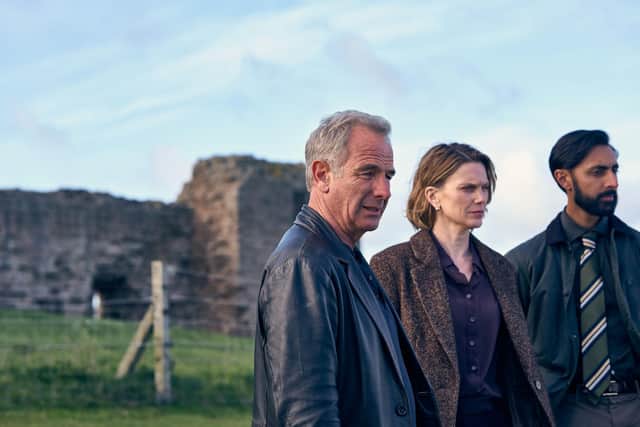 The cast filming at Dunstanburgh Castle. (BBC/Lonesome Pine Productions/Alex Telfer)
