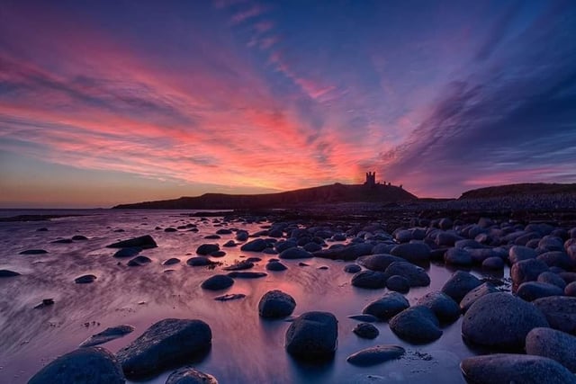 Pink sky in the morning ... a winter sunrise at Dunstanburgh Castle.