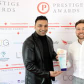 Chris Bather of the Prestige Awards, right, presents Oliul Khan with the award trophy for Magna Tandoori.