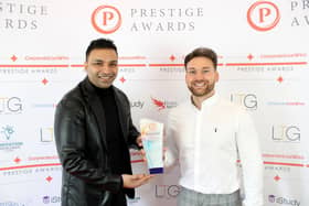 Chris Bather of the Prestige Awards, right, presents Oliul Khan with the award trophy for Magna Tandoori.