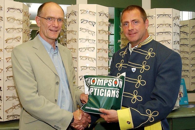 Kevin Thompson, owner of Thompson Opticians, pictured dressed up for Alnwick Fair week, is seen handing over sponsorship money to Michael Henry, one of the race co-ordinators of the Alnwick Harriers Race.