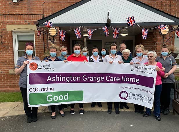 Staff at Ashington Grange Care Home hold up a banner showing their 'good' CQC report.
