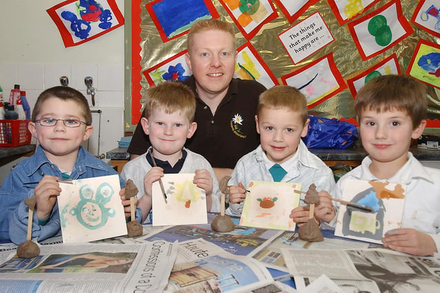 Pupils from Thropton First School with the ceramic tiles they painted, and Mark Nicklin from The Ceramic Experience who showed them what to do in November 2004.