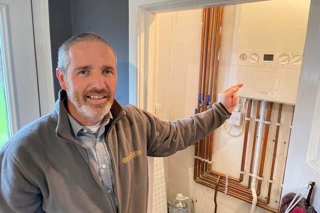 Bernicia project manager Carl Dickson with a newly fitted boiler system at a tenant’s home in Tweedmouth.