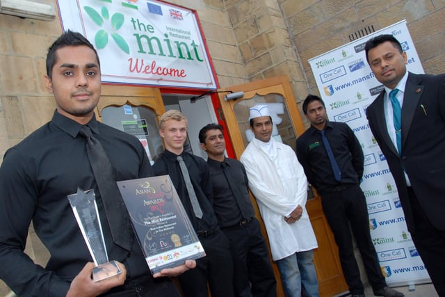 Mansfield's The Mint Restaurant celebrated after winning the Asian Curry Awards, Best Indian Restaurant in the Midlands and East Midlands in 2011. Pictured with the award is General Manager Soficul Choudhury, left, watched by restaurant owner Foysal Choudhury, right and staff