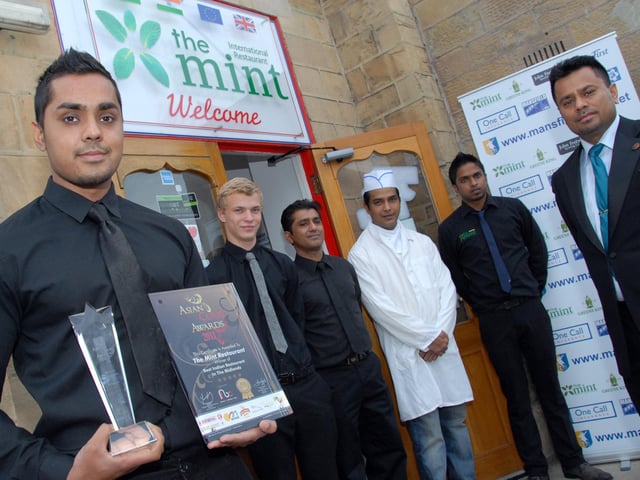 Mansfield's The Mint Restaurant celebrated after winning the Asian Curry Awards, Best Indian Restaurant in the Midlands and East Midlands in 2011. Pictured with the award is General Manager Soficul Choudhury, left, watched by restaurant owner Foysal Choudhury, right and staff