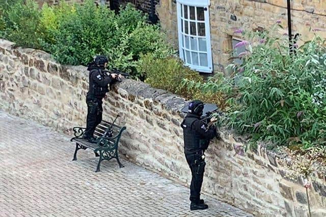 Armed police pictured on Three Tuns Lane following reports of assault