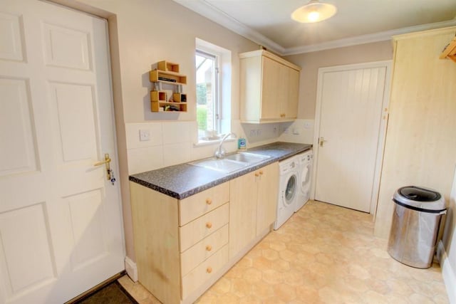 A utility room also leads off the kitchen/diner and contains floor and wall units and bench space with plumbing and spaces for a washing machine and a tumble dryer.