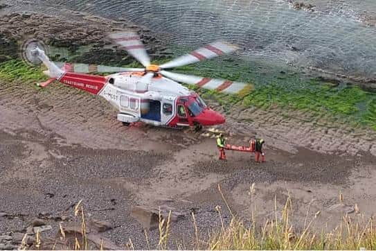 The casualty is taken to the helicopter. Pic: Berwick Coastguard Rescue Team