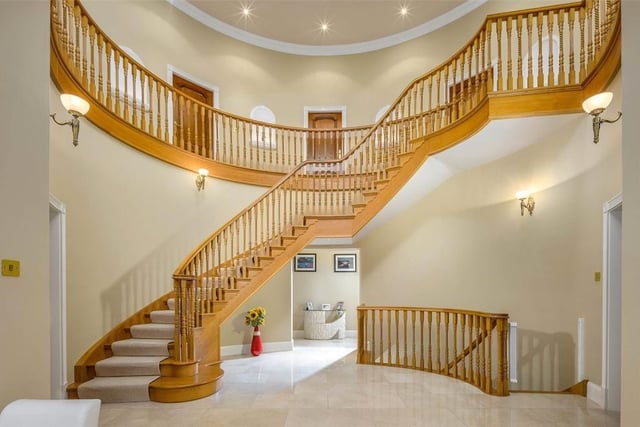 The marble floored reception hall with an elegant oak staircase.