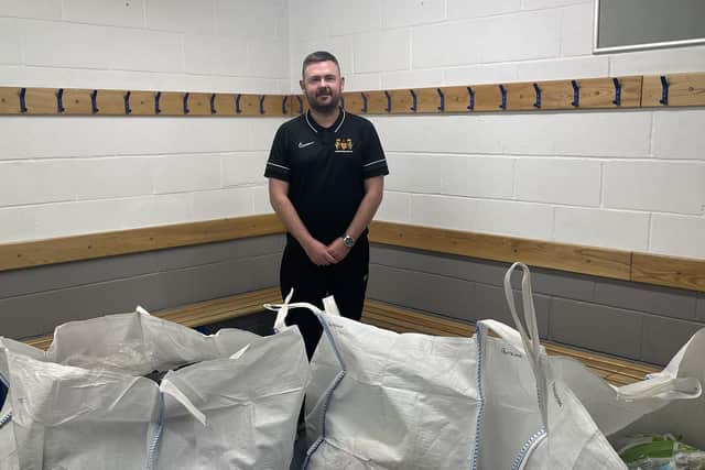 Northumberland FA's Dean Buckle with bags containing copious amounts of donated football kit.
