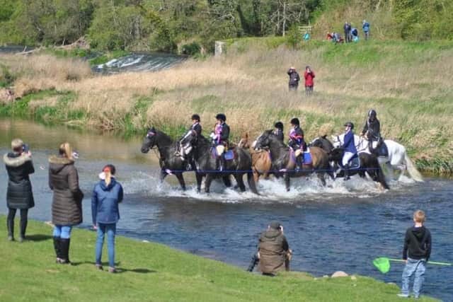 Horses crossing a river during a previous Riding of the Bounds.